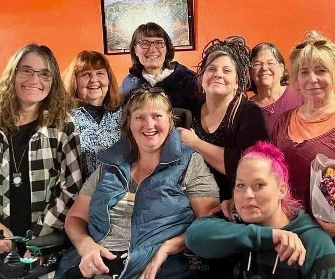 A group of Gg's House volunteers and board members smiling together