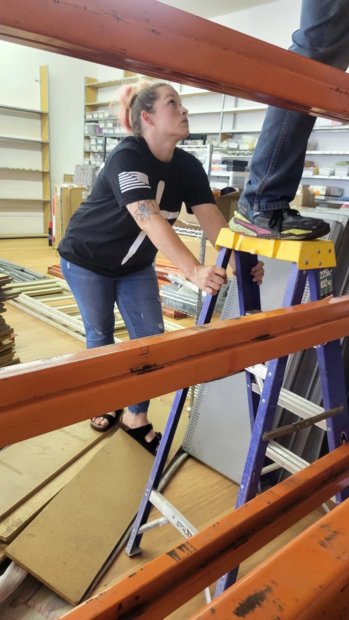 A volunteer sweeping up during the fit-out