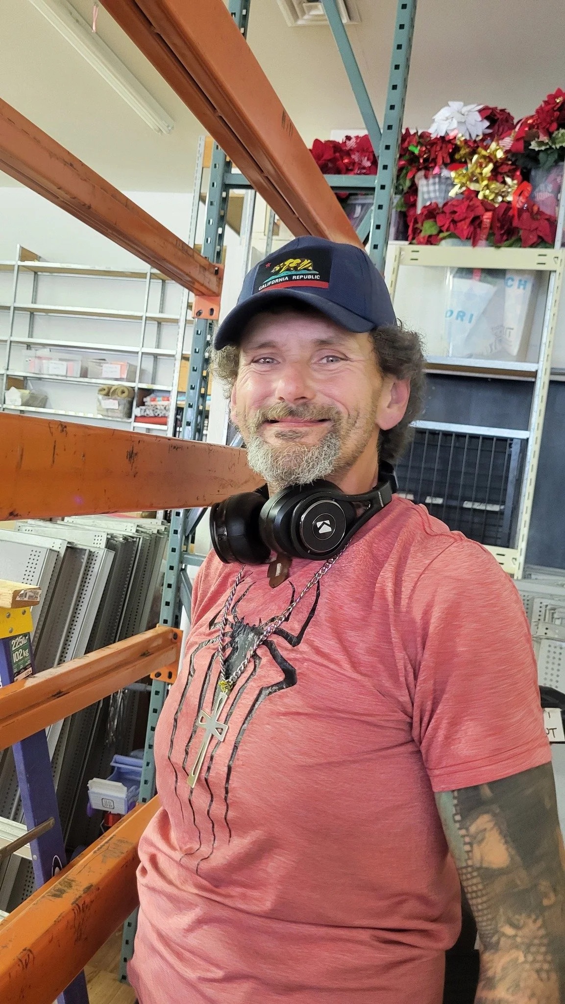A smiling Gg's House volunteer in the stockroom